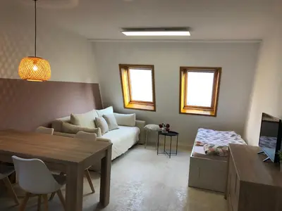 a living room with a couch and a table at Bovec Apartment in Bovec