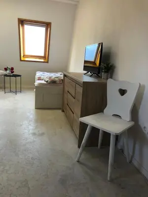 a room with a chair and a desk with a computer at Bovec Apartment in Bovec