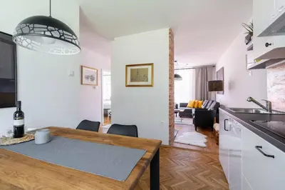 a kitchen and living room with a table and a dining room at Apartma Peček Kranjska Gora in Kranjska Gora