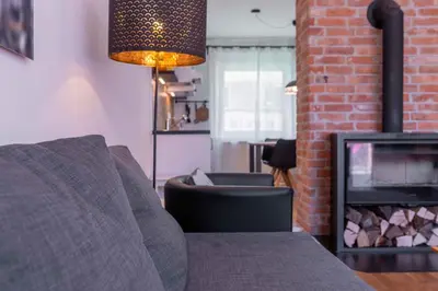 a living room with a couch and a fireplace at Apartma Peček Kranjska Gora in Kranjska Gora