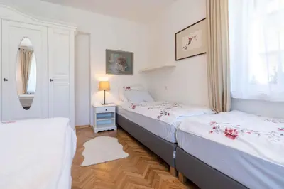 a bedroom with two beds and a window at Apartma Peček Kranjska Gora in Kranjska Gora