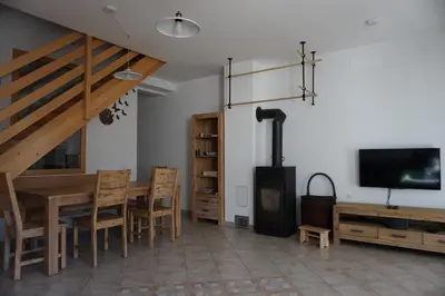 a dining room with a table and a wood stove at ALPIN apartma in Bovec