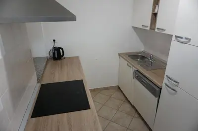 a small kitchen with a counter and a sink at ALPIN apartma in Bovec