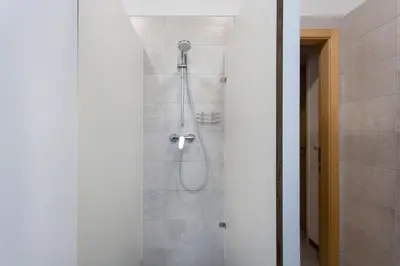 a shower with a shower head in a bathroom at MS Sparrow Hostel in Ljubljana
