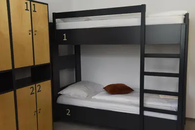 a black bunk bed with a pillow at MS Sparrow Hostel in Ljubljana