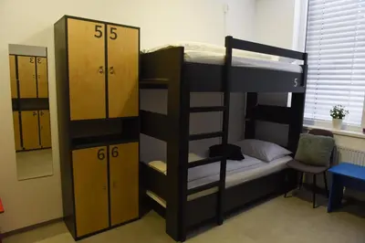 a room with two bunk beds and a mirror at MS Sparrow Hostel in Ljubljana