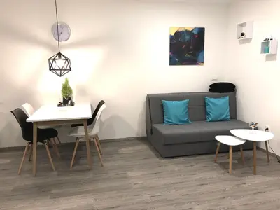 a living room with a couch and a table at Luxury Studio Apartments in Ljubljana