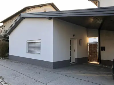 a white garage with a window and a door at Luxury Studio Apartments in Ljubljana