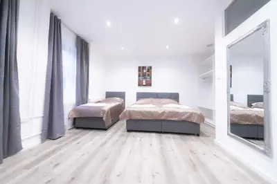 a bedroom with two beds and a large mirror at Apartma City & Free Parking in Ljubljana