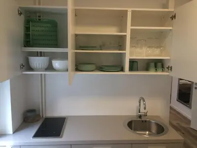 a kitchen with white cabinets and a sink at Apartma City & Free Parking in Ljubljana