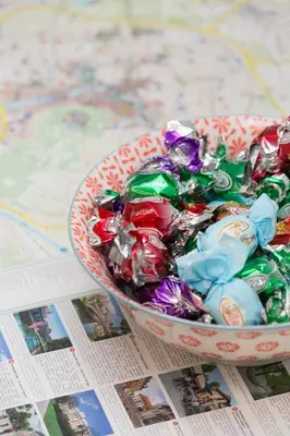 a bowl of candy on top of a map at Big yard in Ljubljana