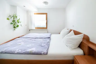 a small bedroom with a bed and a window at Mateja House - Apartments in Žirovnica in Rodine