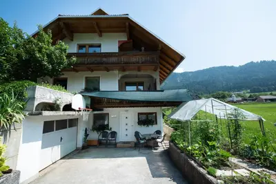 a house with a basketball hoop in front of it at Mateja House - Apartments in Žirovnica in Rodine
