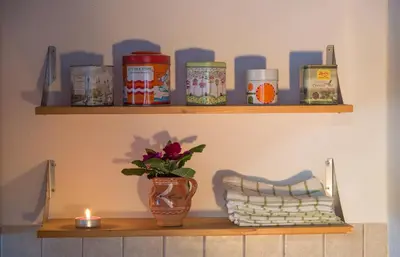 a shelf with a vase and a candle on it at Apartma PEPI in Rogaška Slatina