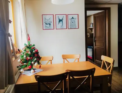 a dining room table with a christmas tree on it at Vall’s apartment- by ski slopes in Kranjska Gora