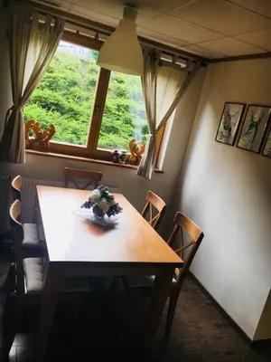 a table and chairs in a room with a window at Vall’s apartment- by ski slopes in Kranjska Gora