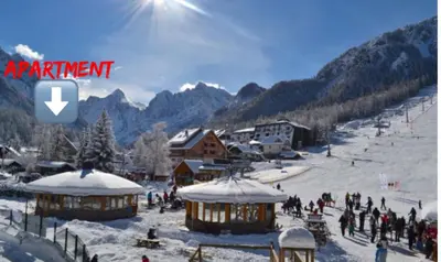a group of people on a ski slope in the snow at Vall’s apartment- by ski slopes in Kranjska Gora