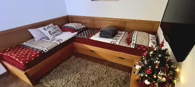 a room with two beds and a christmas tree at Vall’s apartment- by ski slopes in Kranjska Gora