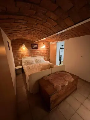 a bedroom with a bed and a brick wall at apartma 