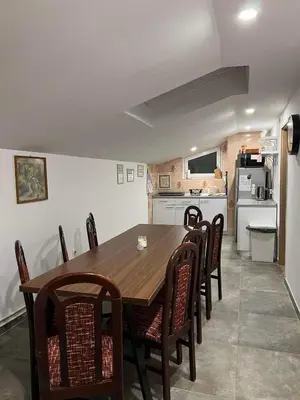 a kitchen and dining room with a wooden table and chairs at apartma 