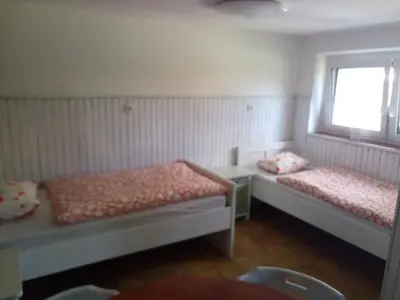 a room with two beds and a window at apartma 