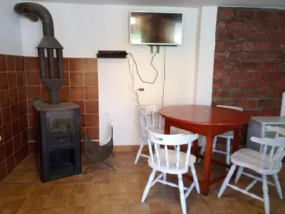a room with a table and a wood stove at apartma 