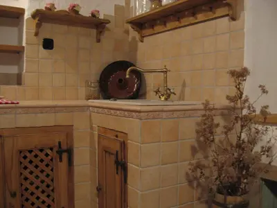 a kitchen with a sink and a fan on the wall at ETNO HOUSE GOSTECE- Suite with Finnish sauna in Mozirje
