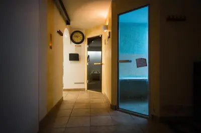 a hallway with a door and a clock on the wall at Apartments Lavric in Nova Vas
