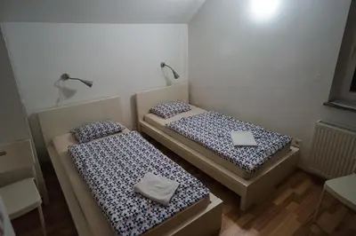 two beds in a small room at Apartments Lavric in Nova Vas
