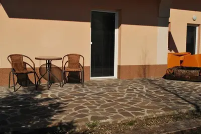 a patio with chairs and a table in a building at Apartments Lavric in Nova Vas