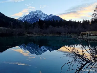 a reflection of a mountain in a lake at Mountain Charm in Kranjska Gora