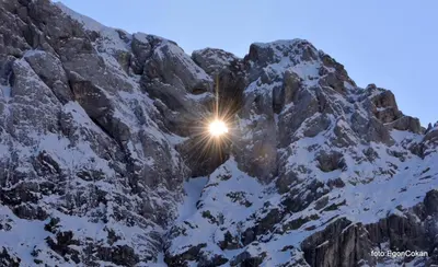 a sun shining on the side of a snow covered mountain at Mountain Charm in Kranjska Gora