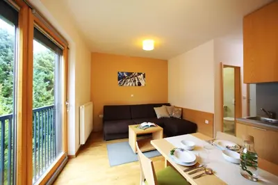 a living room with a couch and a table at Apartments and Rooms Bernik in Kranjska Gora