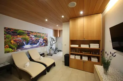 a room with two chairs and a painting on the wall at Apartments and Rooms Bernik in Kranjska Gora