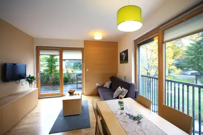 a living room with a couch and a table at Apartments and Rooms Bernik in Kranjska Gora