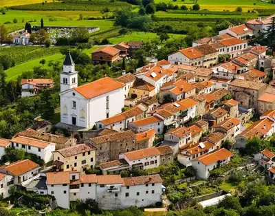 an aerial view of a village with a church at Apartma in soba Vipavski Križ in Ajdovščina