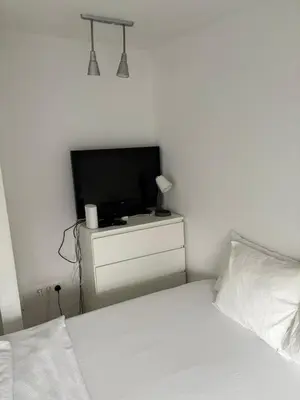 a bedroom with a bed and a television on a dresser at Industrial Studio 6 in Ljubljana