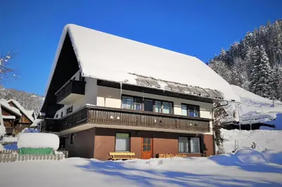a building covered in snow with a lot of snow at Apartma Andrej in Rateče