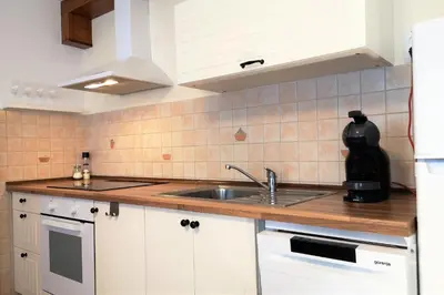 a kitchen with white cabinets and a sink at Apartma Andrej in Rateče
