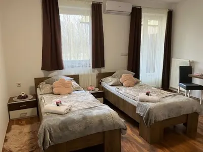 a bedroom with two beds with towels on them at Apartments-rooms Vogrinec in Ptuj