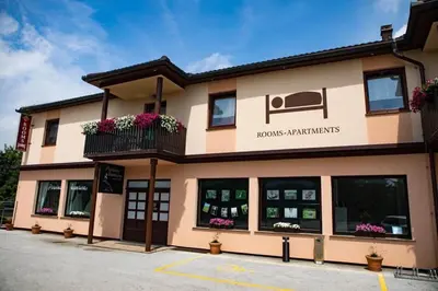 a building with a sign that reads honolulu armaments at Apartments-rooms Vogrinec in Ptuj