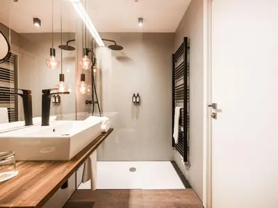 a bathroom with a white sink and a shower at Hotel City Maribor in Maribor