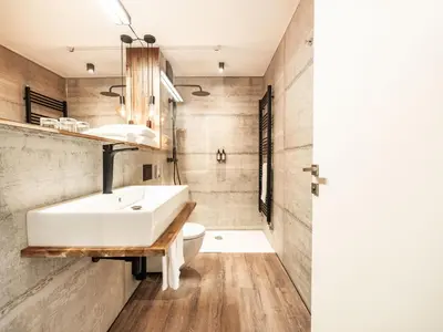 a bathroom with a white sink and a toilet at Hotel City Maribor in Maribor