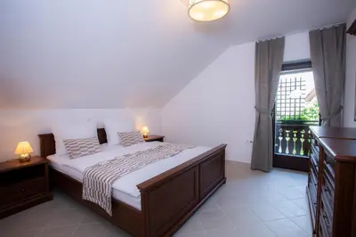 a bedroom with a large bed and a window at House Klasika - Adults Only in Bled