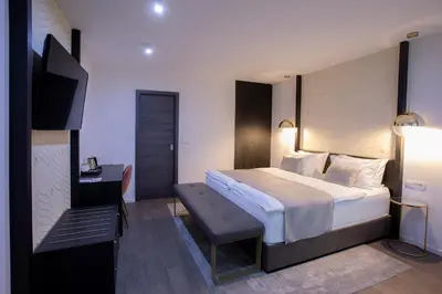 a bedroom with a bed and a desk and a television at House Klasika - Adults Only in Bled