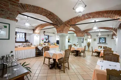 a restaurant with tables and chairs in a room at House Klasika - Adults Only in Bled
