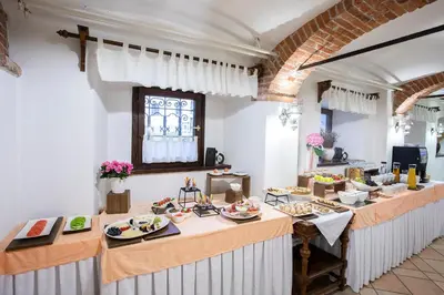 a kitchen with a table with plates of food on it at House Klasika - Adults Only in Bled