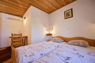 a bedroom with a bed and a wooden ceiling at Tourist Farm Firbas in Cerkvenjak