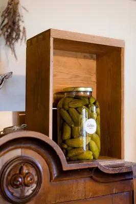 a jar of pickles in a wooden box at Tourist Farm Firbas in Cerkvenjak