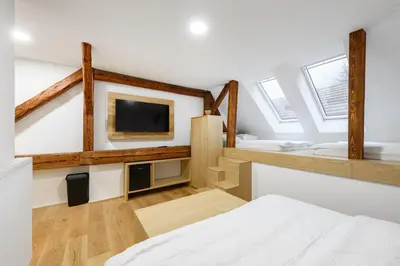 a room with a bed and a tv and windows at B&B Pri Peclju in Podgrad
